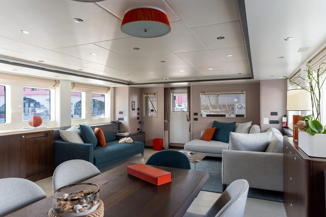 The salon features a spacious and elegantly designed seating area with modern furnishings and ample natural light. aboard GRANIL Yacht for Sale
