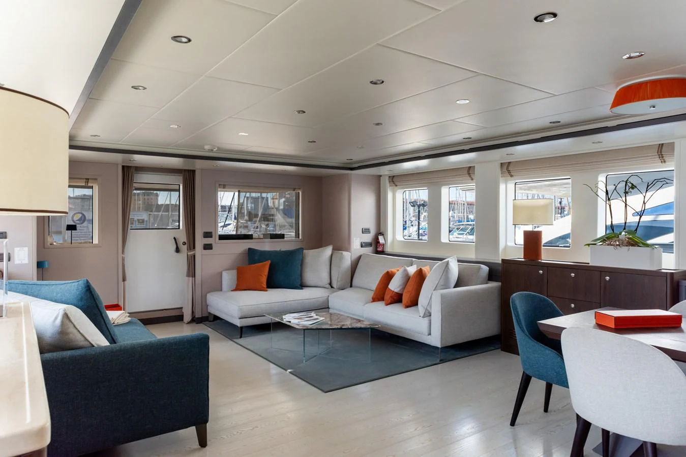 The salon features modern furnishings with ample seating and natural light. aboard GRANIL Yacht for Sale