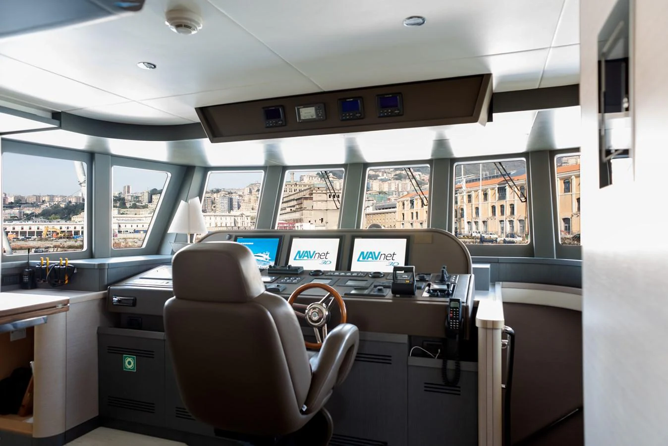 The helm station offers a commanding view with advanced navigation systems and a comfortable captain's chair. aboard GRANIL Yacht for Sale