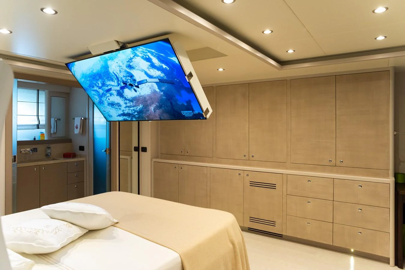 The stateroom features a modern design with ample storage and a ceiling-mounted television. aboard GRANIL Yacht for Sale