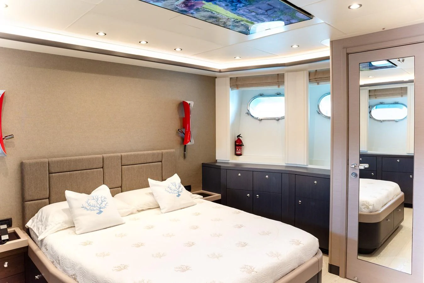 The stateroom features a plush bed with elegant decor and ample natural light. aboard GRANIL Yacht for Sale
