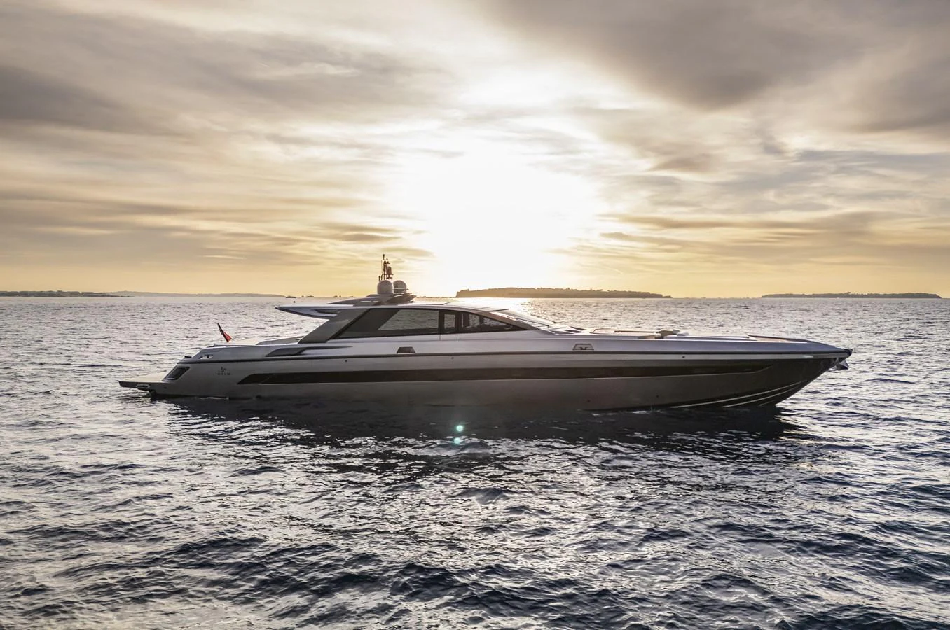 A sleek yacht glides across the water at sunset, showcasing its elegant design. aboard SEXY ME Yacht for Sale