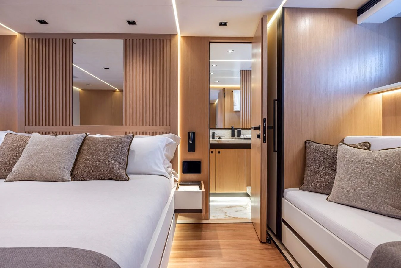 The stateroom features a luxurious bed, cozy seating area, and an ensuite bathroom with modern finishes. aboard SEXY ME Yacht for Sale