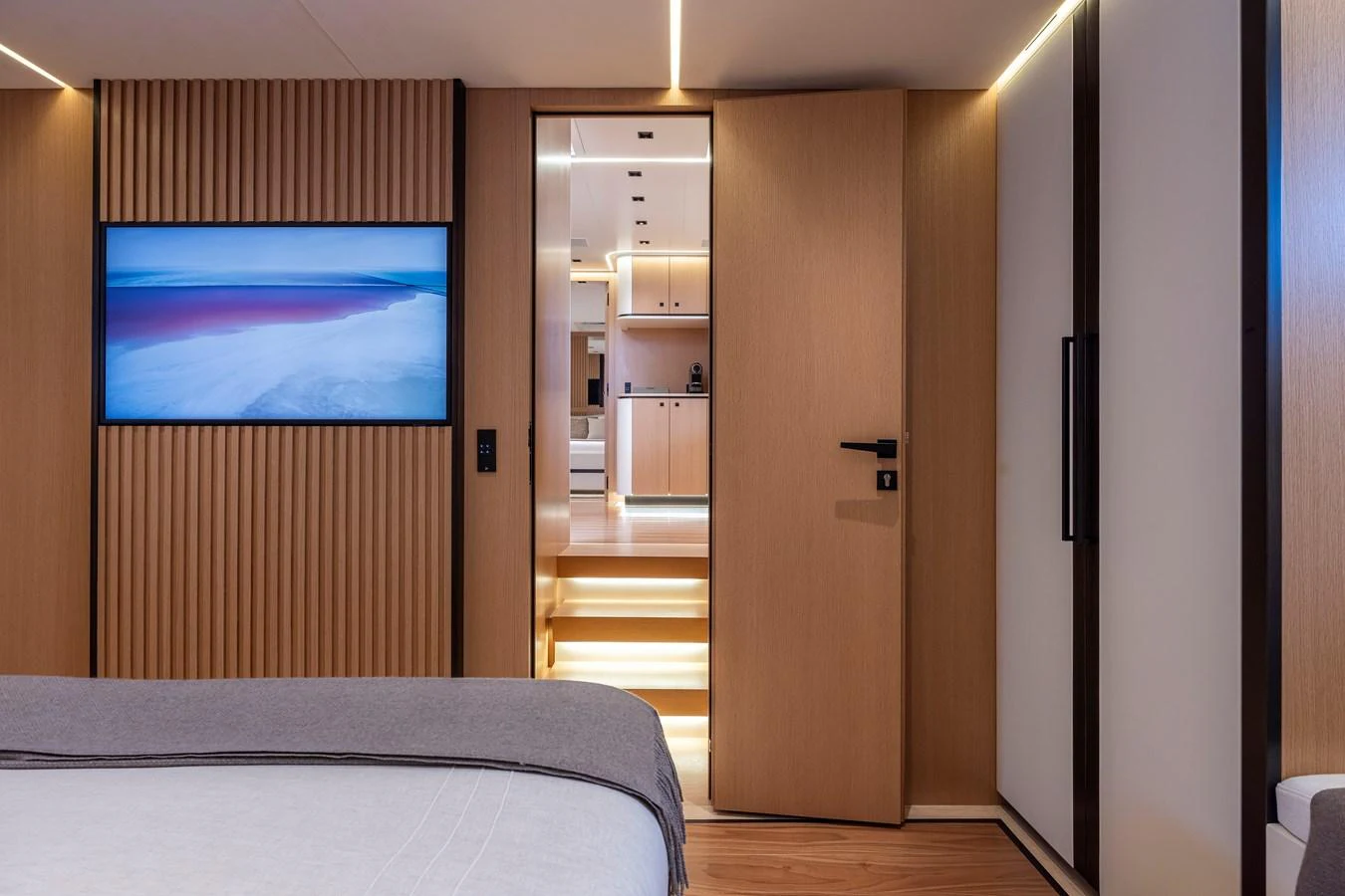 A luxurious stateroom with modern wood paneling and a view into the hallway. aboard SEXY ME Yacht for Sale