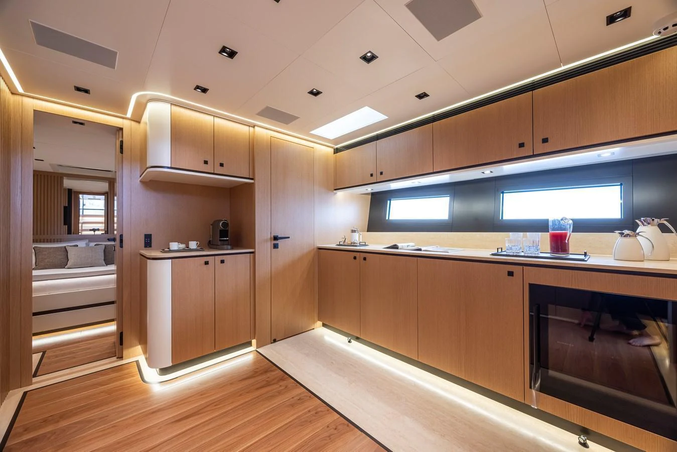 The yacht's galley features modern wooden cabinetry, sleek appliances, and ample counter space, creating a stylish and functional cooking area. aboard SEXY ME Yacht for Sale