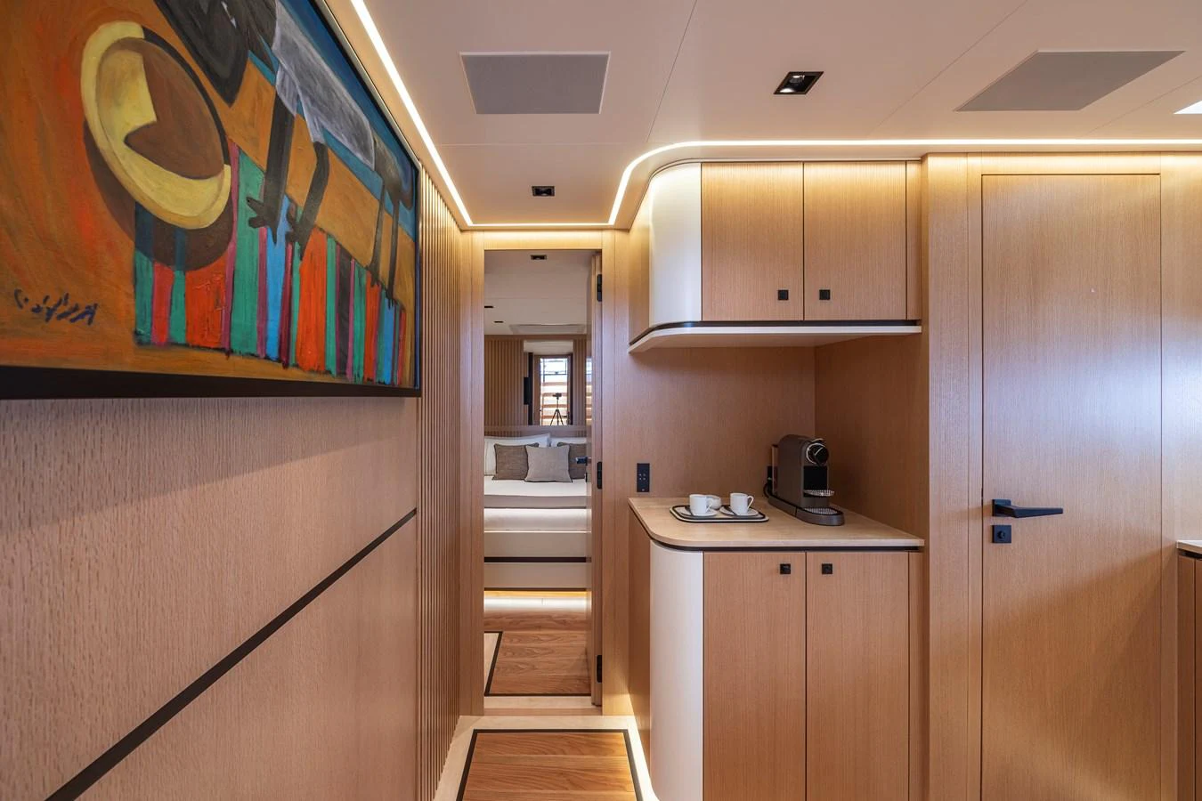 The yacht's interior features a sleek hallway with modern wooden paneling and tasteful artwork. aboard SEXY ME Yacht for Sale
