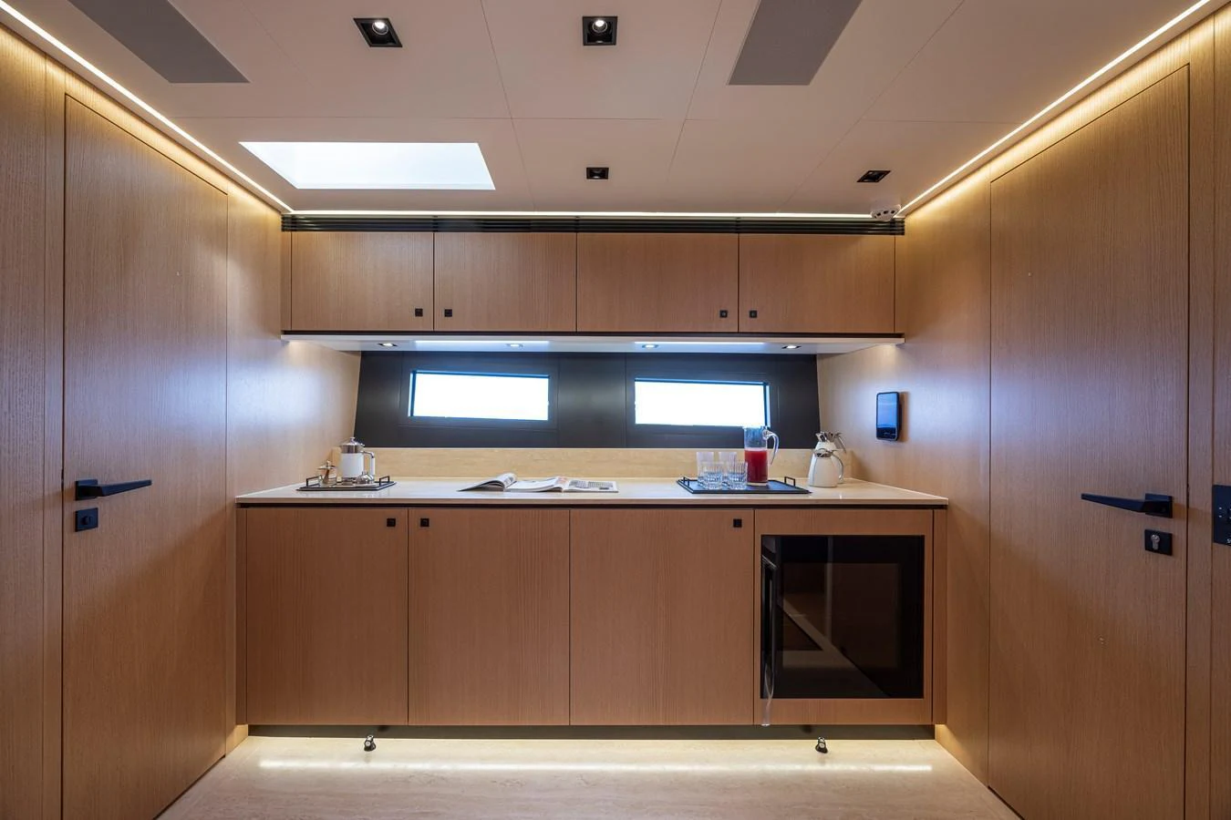 The galley features modern cabinetry and ample natural light. aboard SEXY ME Yacht for Sale