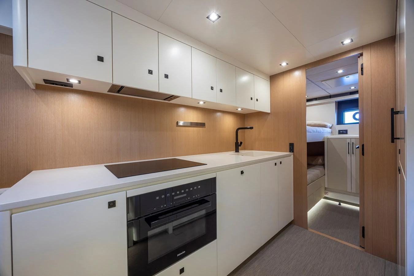 The galley features modern cabinetry and appliances, offering a sleek and functional space for meal preparation. aboard SEXY ME Yacht for Sale