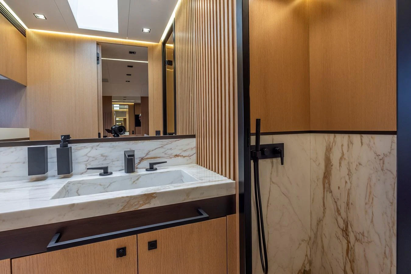 The yacht's bathroom features a sleek design with marble accents and modern fixtures. aboard SEXY ME Yacht for Sale