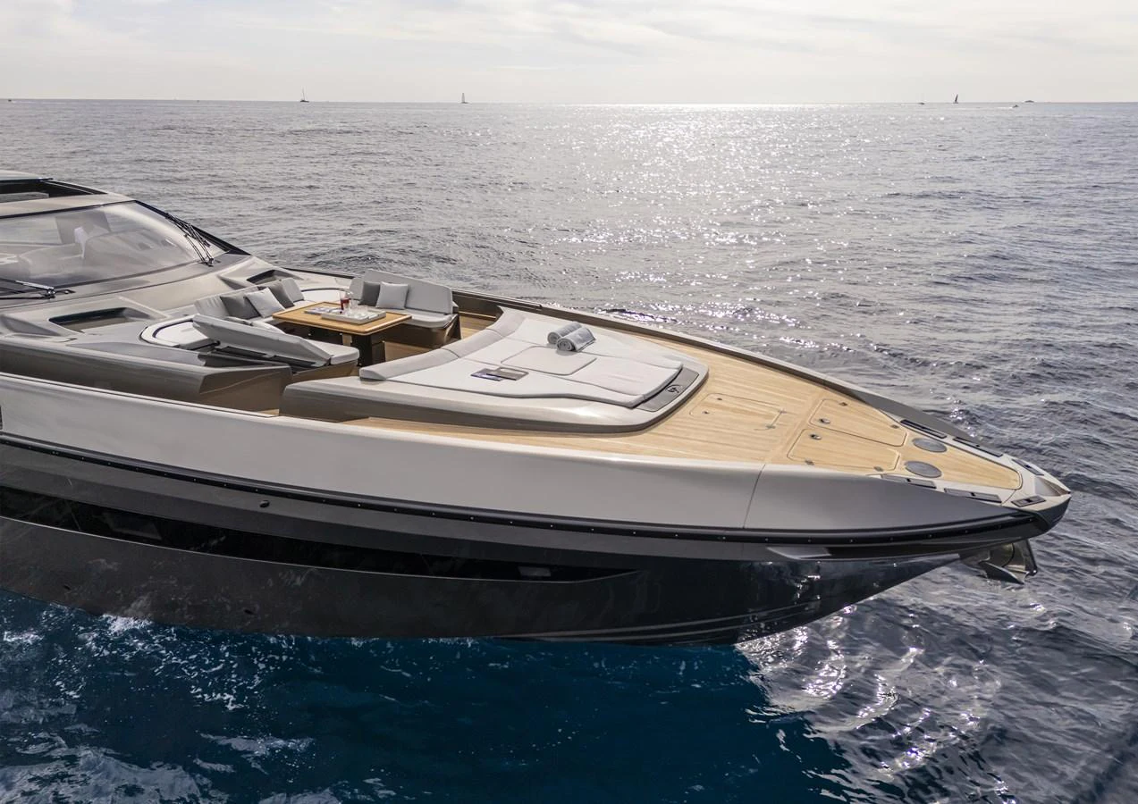 A sleek yacht glides over the water with a spacious sunbathing area on the bow. aboard SEXY ME Yacht for Sale