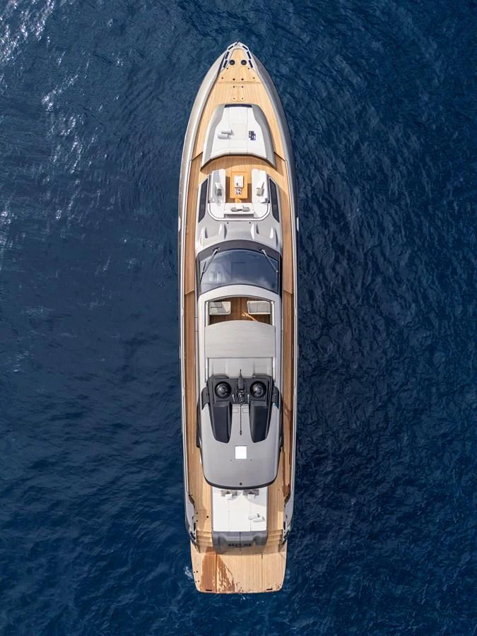 An aerial view of a sleek yacht cruising on deep blue waters. aboard SEXY ME Yacht for Sale