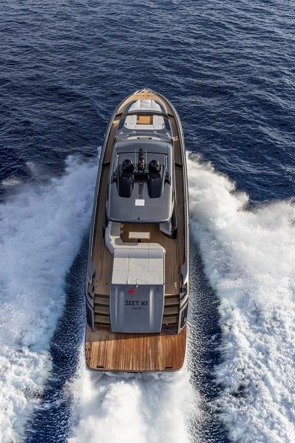 A sleek yacht cruises through the open water, leaving a trail of white foam in its wake. aboard SEXY ME Yacht for Sale