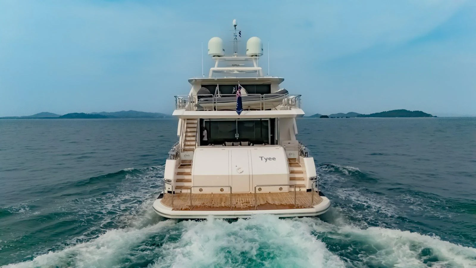 A luxurious yacht cruising on open waters with a view of the aft deck. aboard AVELINE Yacht for Sale