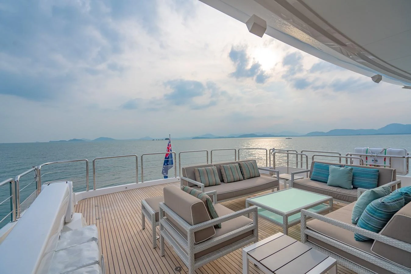 The aft deck offers a serene seating area with comfortable sofas and a stunning ocean view. aboard AVELINE Yacht for Sale