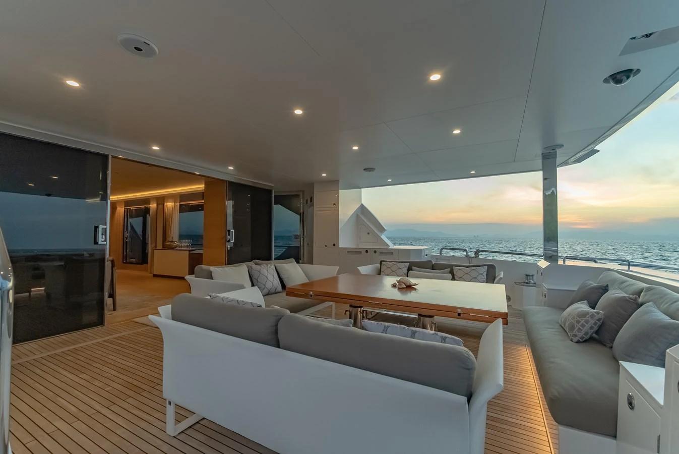 The aft deck features a spacious seating area with elegant furnishings and a stunning ocean view. aboard AVELINE Yacht for Sale