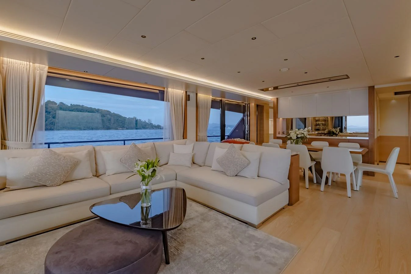 The salon features a spacious seating area with large windows offering stunning views. aboard AVELINE Yacht for Sale