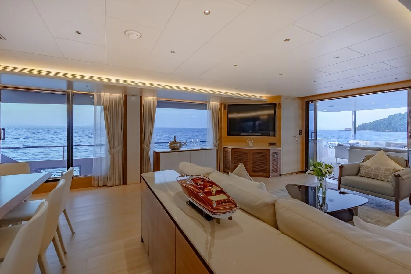 The salon offers a spacious and elegant area with panoramic ocean views, comfortable seating, and modern entertainment amenities. aboard AVELINE Yacht for Sale