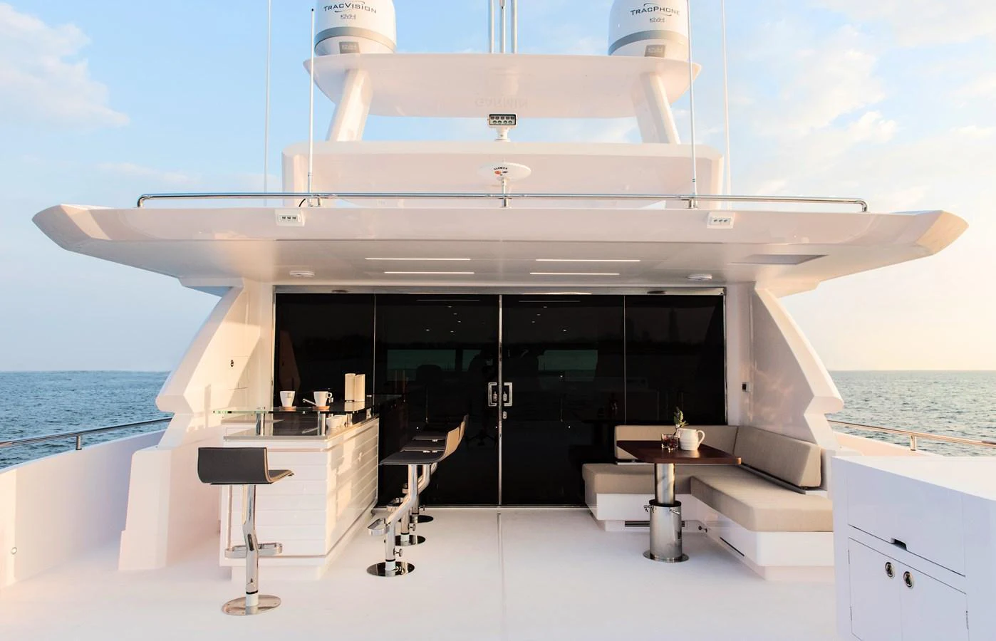 The aft deck features a stylish bar area with seating, perfect for entertaining while enjoying the ocean view. aboard AQUA LIFE Yacht for Sale
