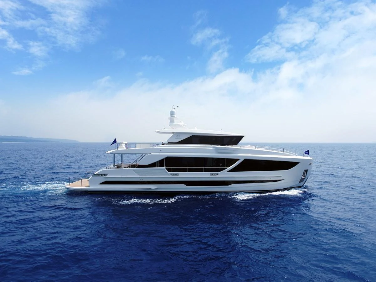 A sleek and modern yacht glides effortlessly across the open sea under a clear blue sky. aboard AQUA LIFE Yacht for Sale