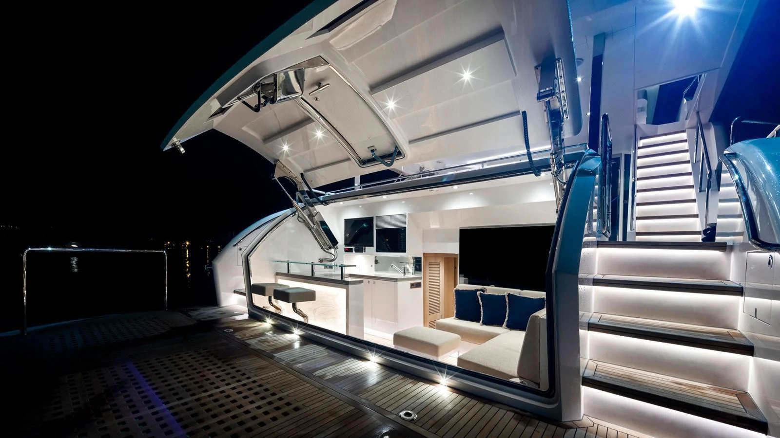 The yacht's aft deck is beautifully illuminated, showcasing a luxurious and inviting space for evening relaxation. aboard AQUA LIFE Yacht for Sale
