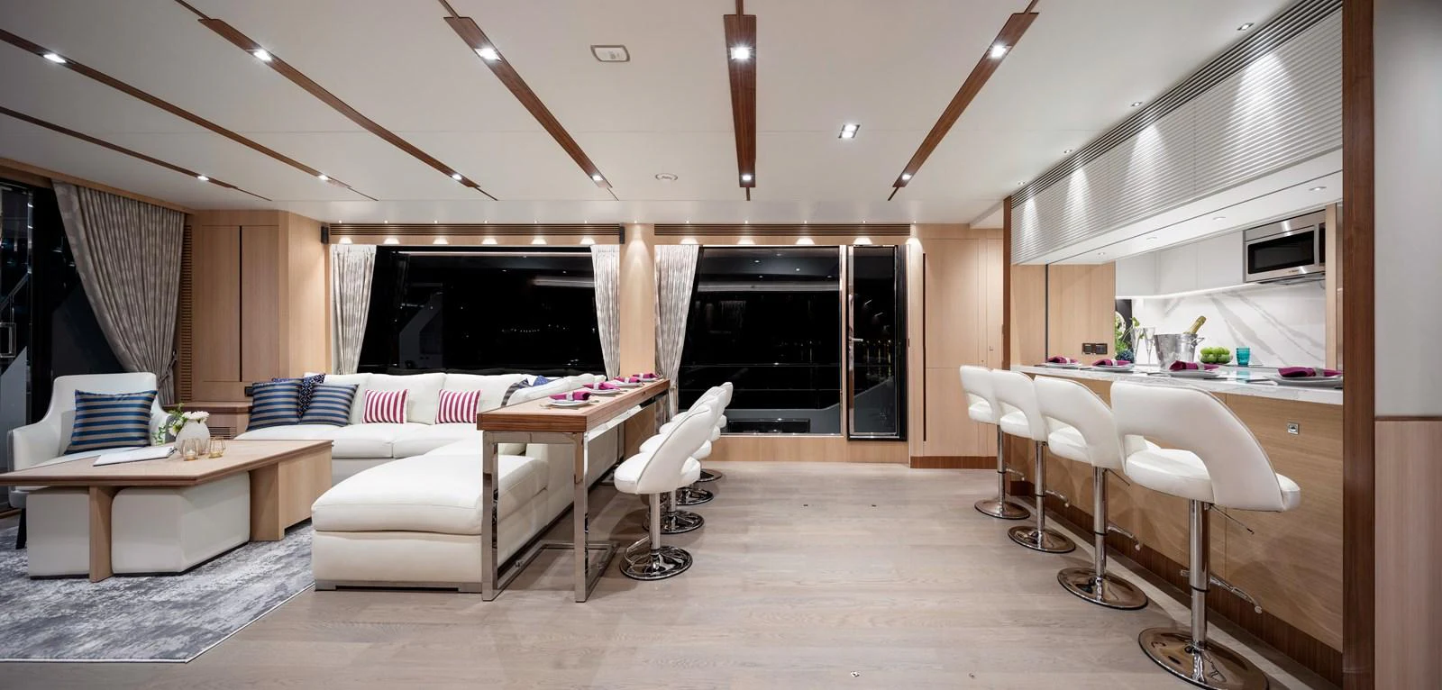 The salon features a spacious and modern design with comfortable seating and a sleek bar area. aboard AQUA LIFE Yacht for Sale