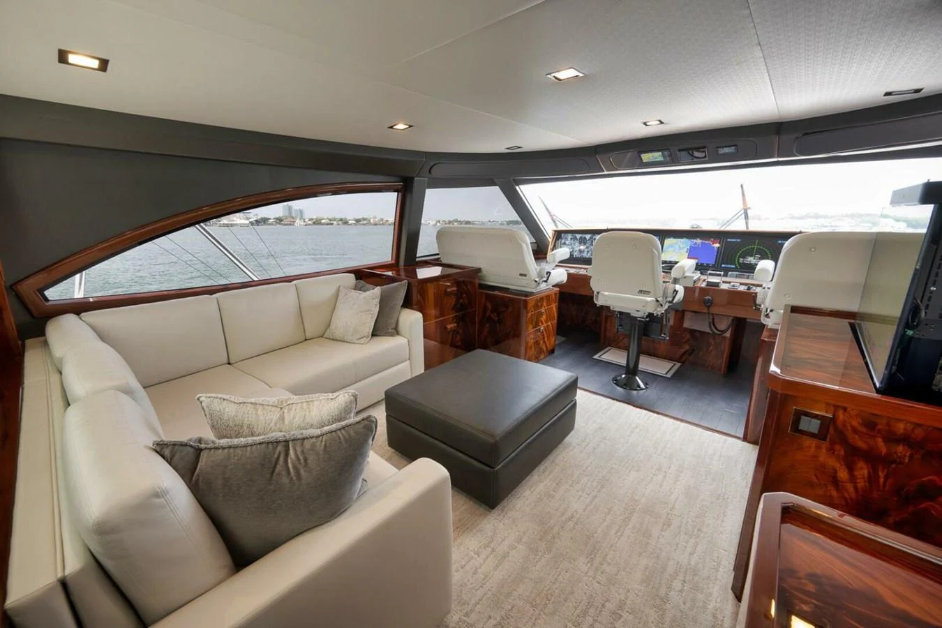 The helm area features luxurious seating and a spacious layout with a view of the water. aboard NIKKI BELLA Yacht for Sale