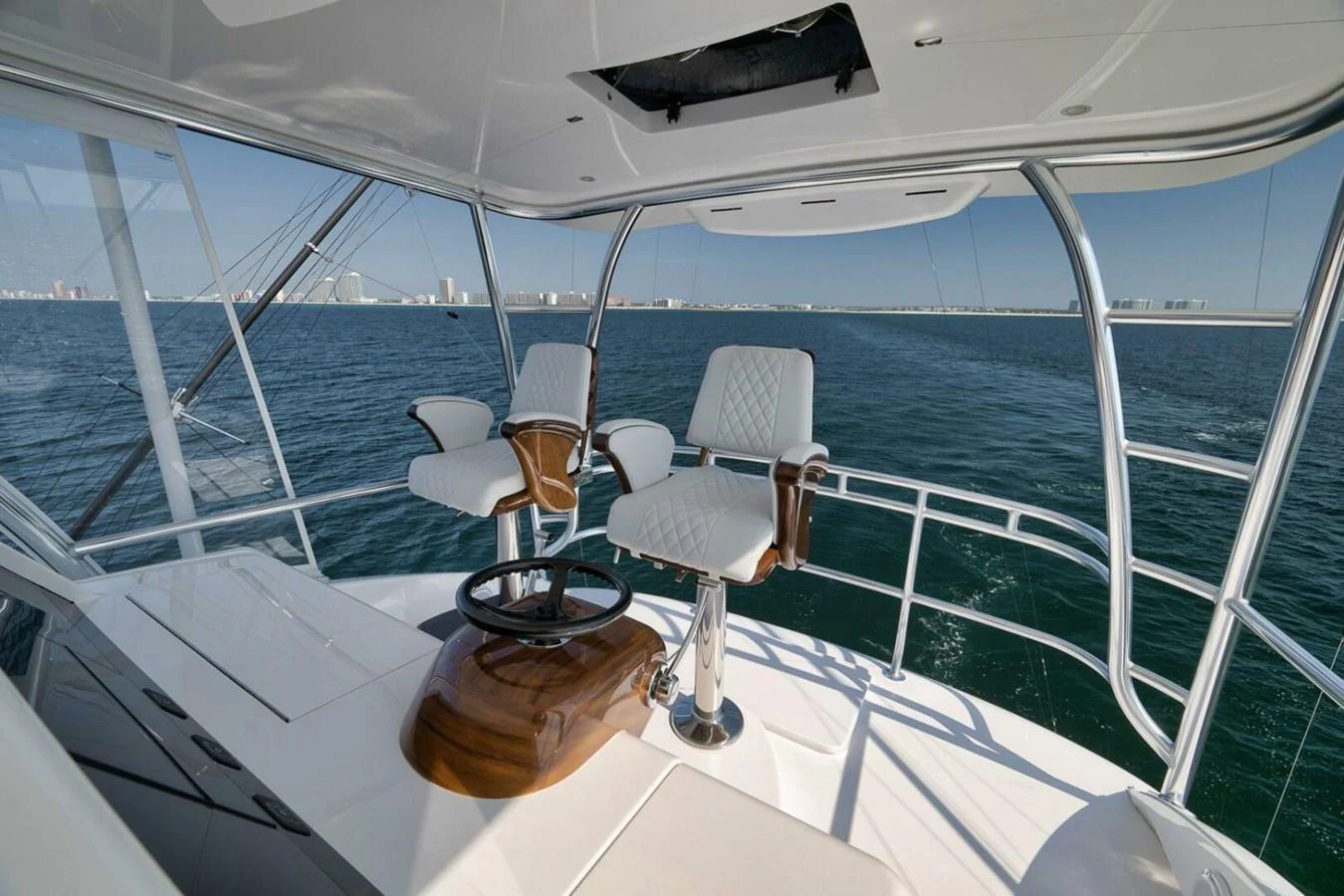 The helm offers a commanding view of the open water with comfortable seating and modern controls. aboard NIKKI BELLA Yacht for Sale