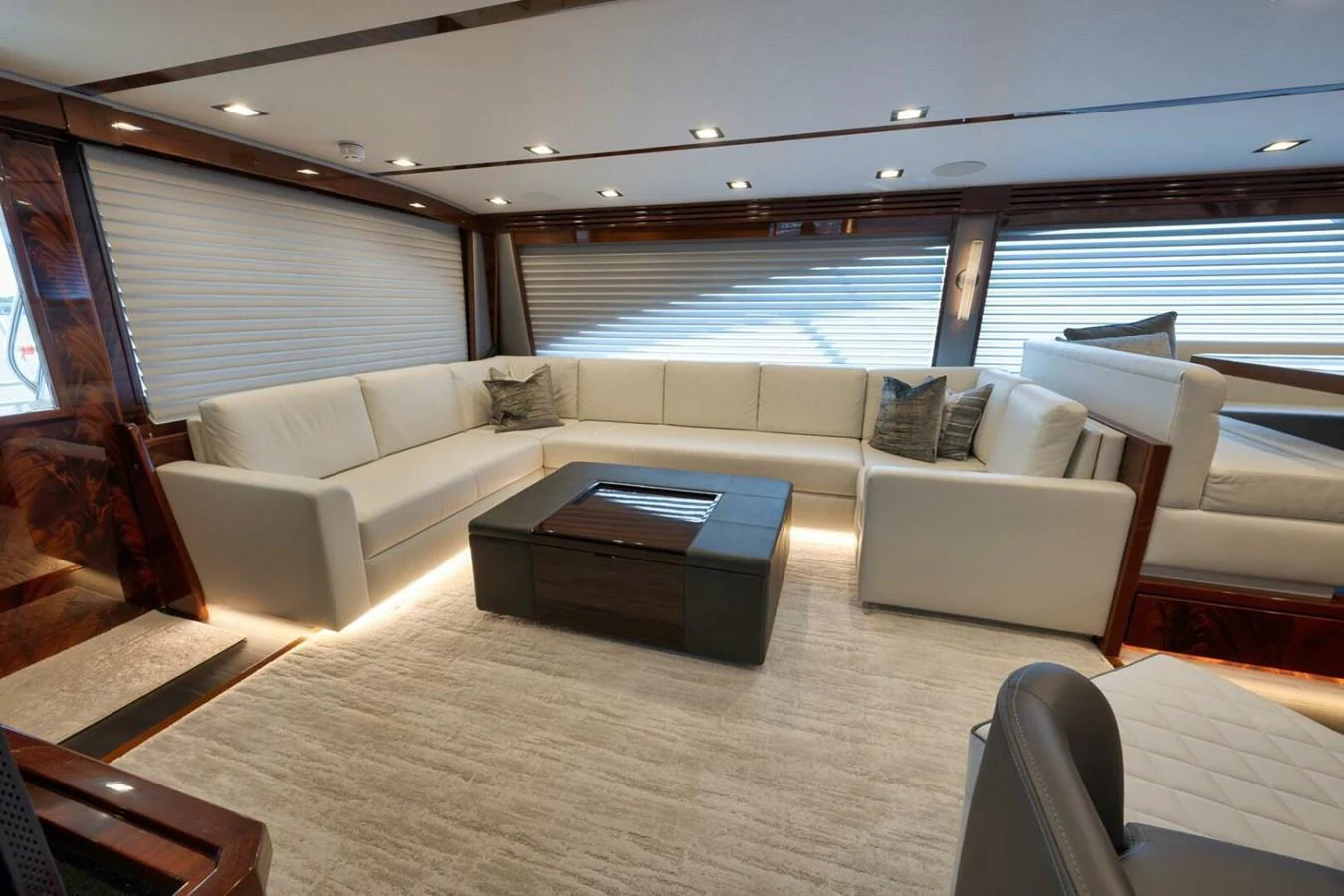The salon features a spacious and elegant seating area with plush white sofas and modern decor. aboard NIKKI BELLA Yacht for Sale