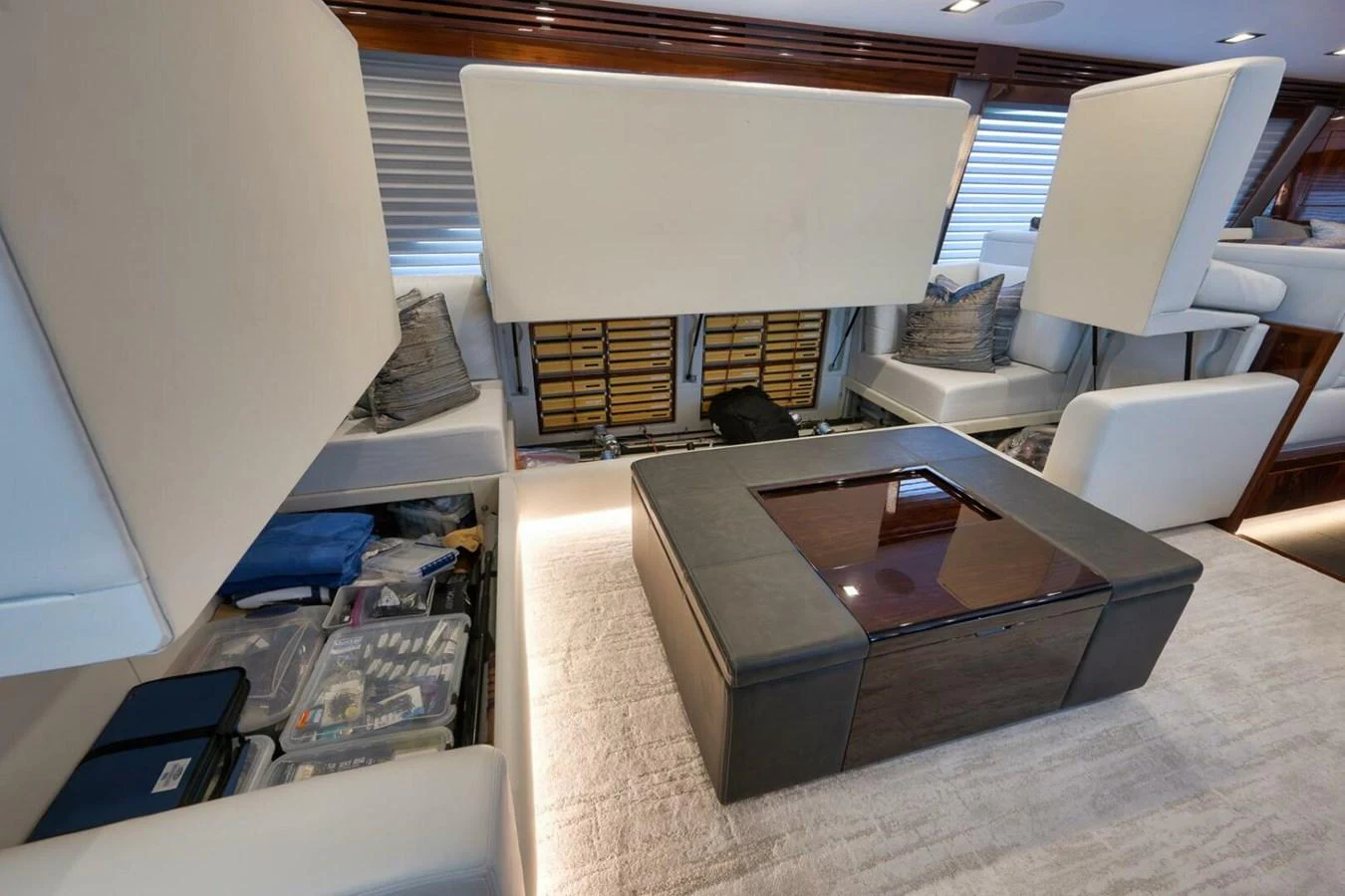 The yacht's interior features a versatile seating area with ample storage space beneath the cushions. aboard NIKKI BELLA Yacht for Sale