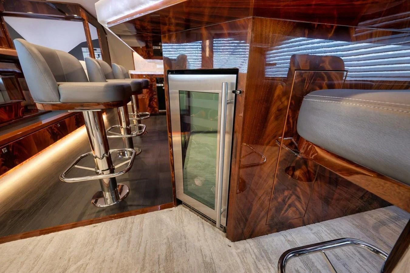 The image showcases a luxurious interior bar area with high-end finishes and comfortable seating. aboard NIKKI BELLA Yacht for Sale