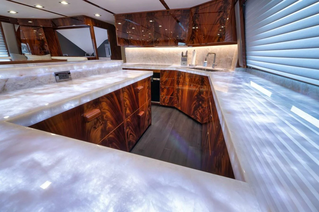 The galley features luxurious wood cabinetry and a sleek marble countertop, creating an elegant and functional space. aboard NIKKI BELLA Yacht for Sale