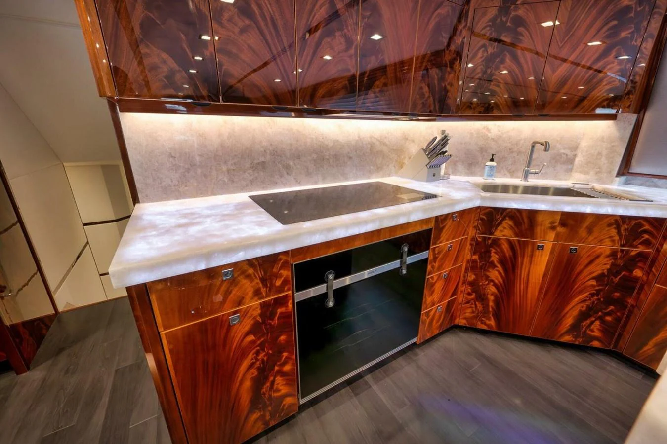 The yacht's galley features luxurious wood cabinetry and modern appliances, creating a sophisticated and functional space. aboard NIKKI BELLA Yacht for Sale