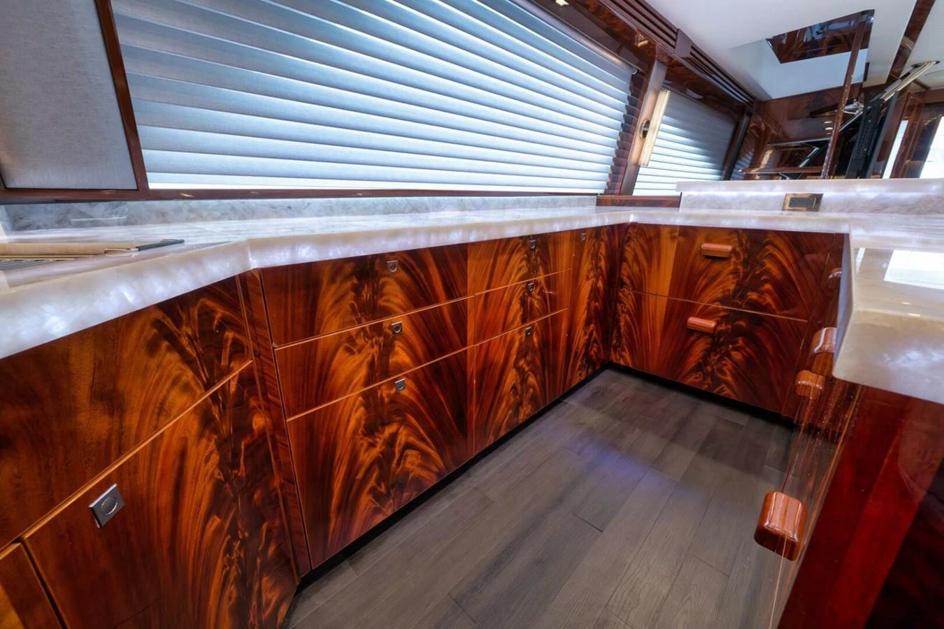 The yacht's galley features luxurious wooden cabinetry and modern countertops. aboard NIKKI BELLA Yacht for Sale