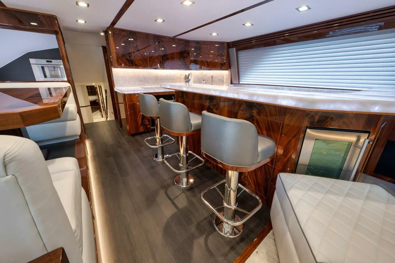 The yacht's galley features a sleek design with high-end finishes and comfortable seating. aboard NIKKI BELLA Yacht for Sale