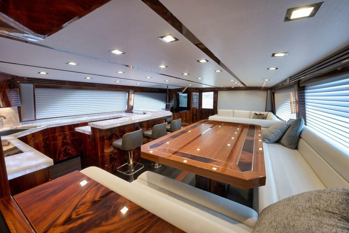 The yacht's salon features luxurious wood finishes, comfortable seating, and modern lighting. aboard NIKKI BELLA Yacht for Sale