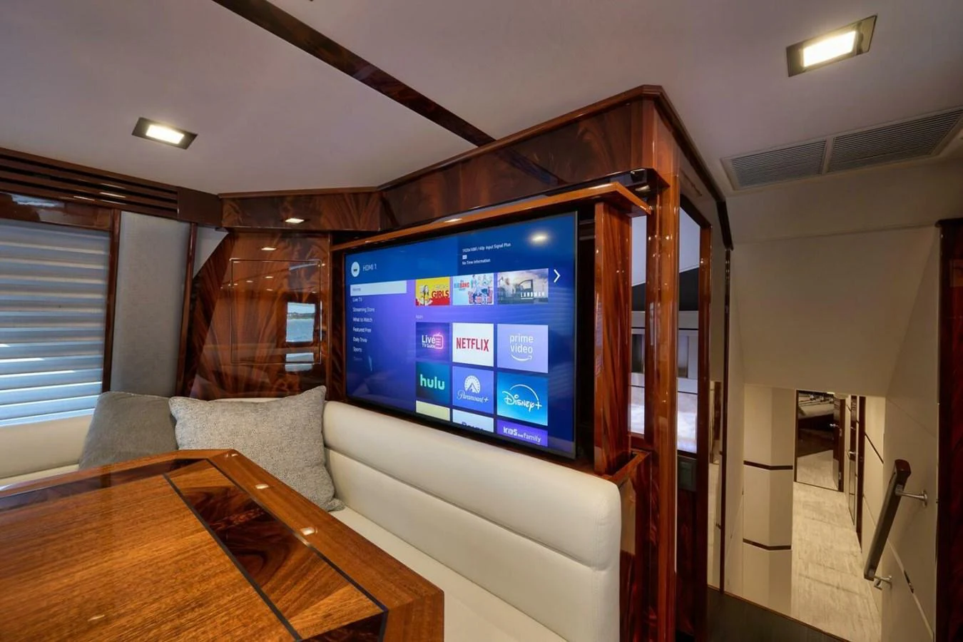 The yacht's salon features a large flat-screen TV and luxurious wood finishes. aboard NIKKI BELLA Yacht for Sale