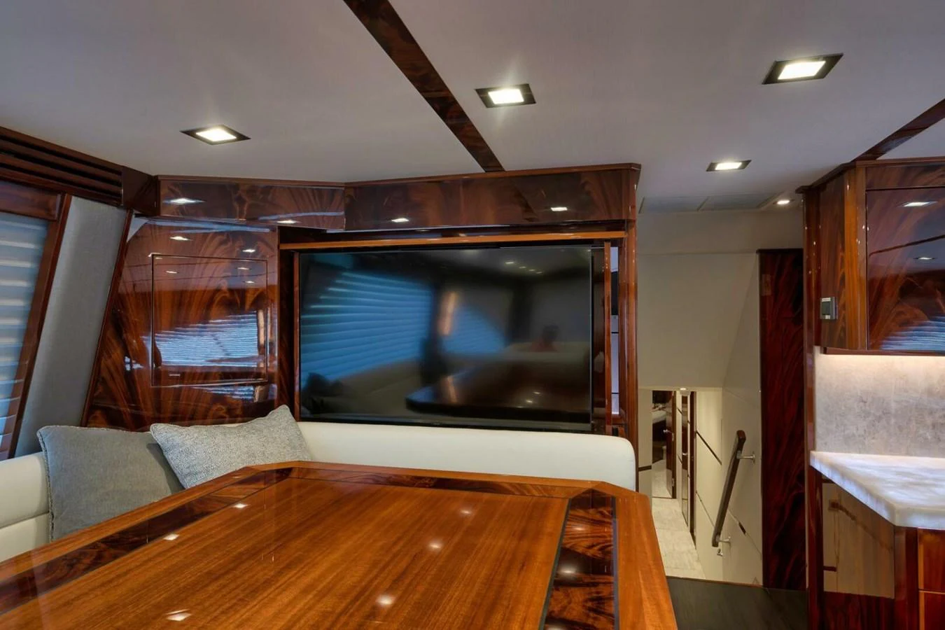 The yacht's interior features a luxurious seating area with a large flat-screen TV and elegant wood finishes. aboard NIKKI BELLA Yacht for Sale