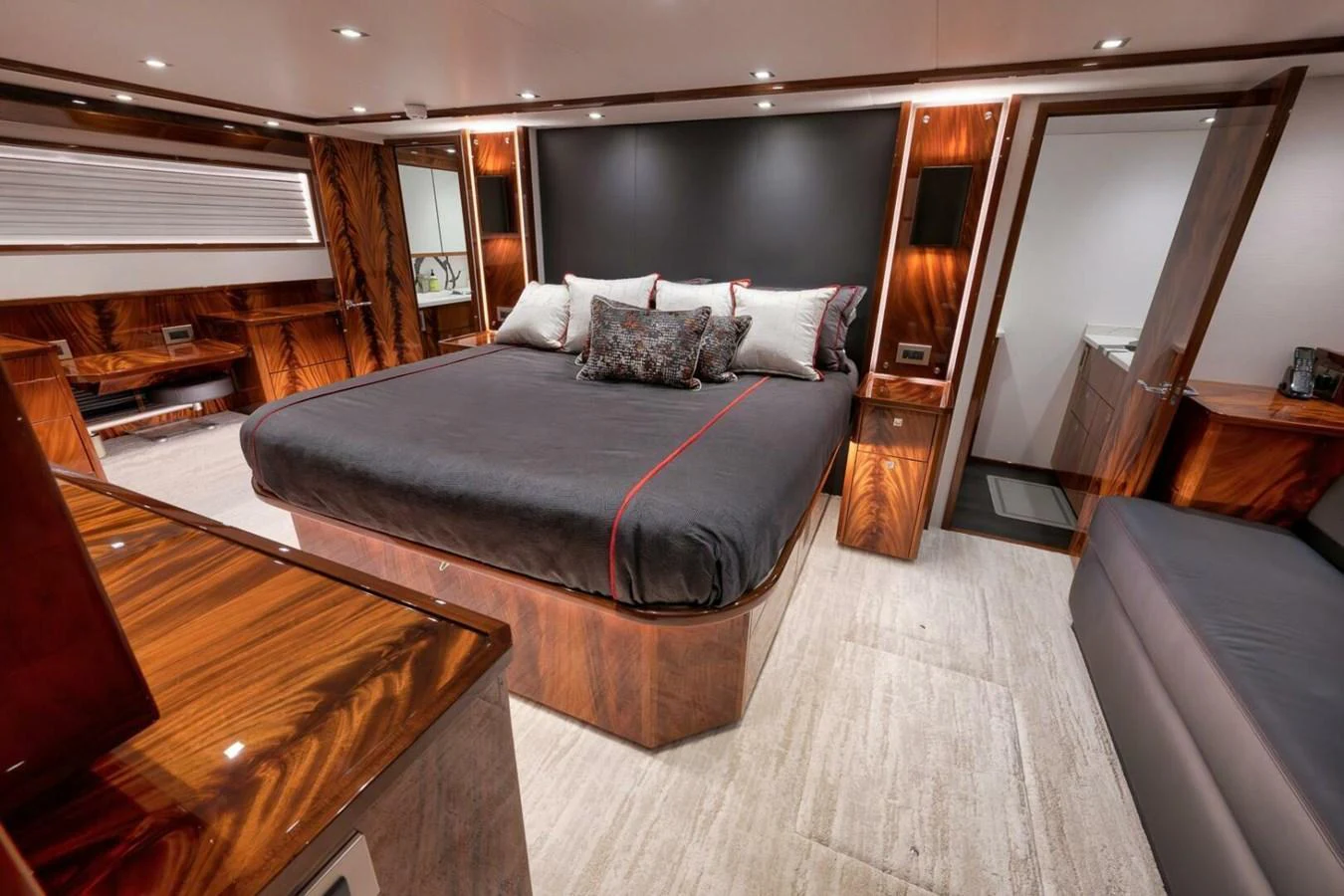 The master stateroom features a luxurious bed with rich wood accents and modern lighting. aboard NIKKI BELLA Yacht for Sale