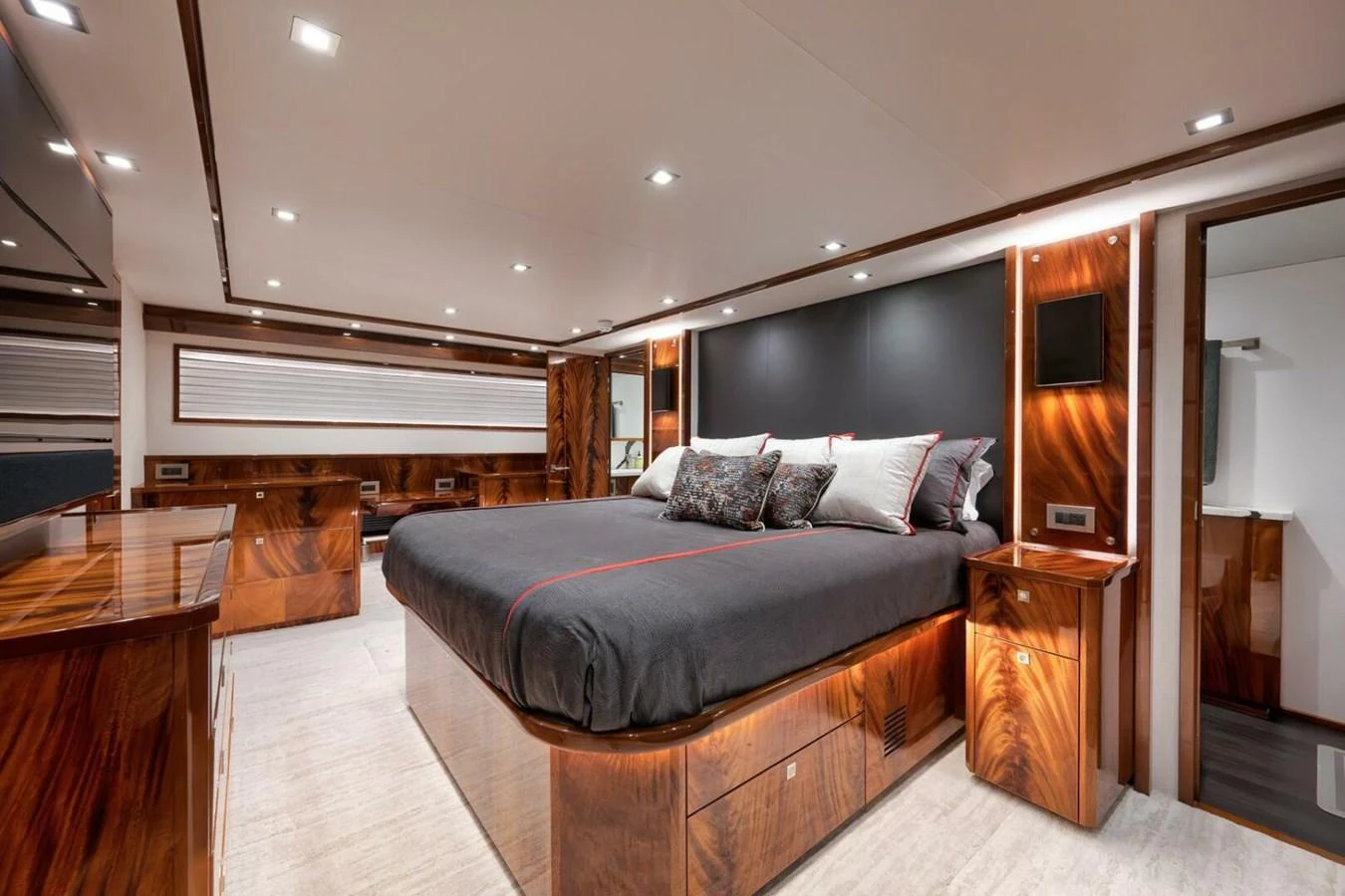 The master stateroom features a luxurious bed with elegant wood finishes and modern lighting. aboard NIKKI BELLA Yacht for Sale