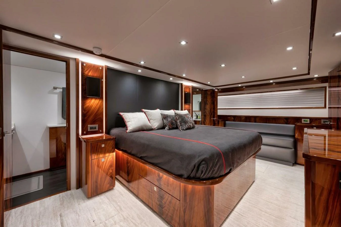 The master stateroom features a luxurious bed with elegant wood paneling and modern lighting. aboard NIKKI BELLA Yacht for Sale