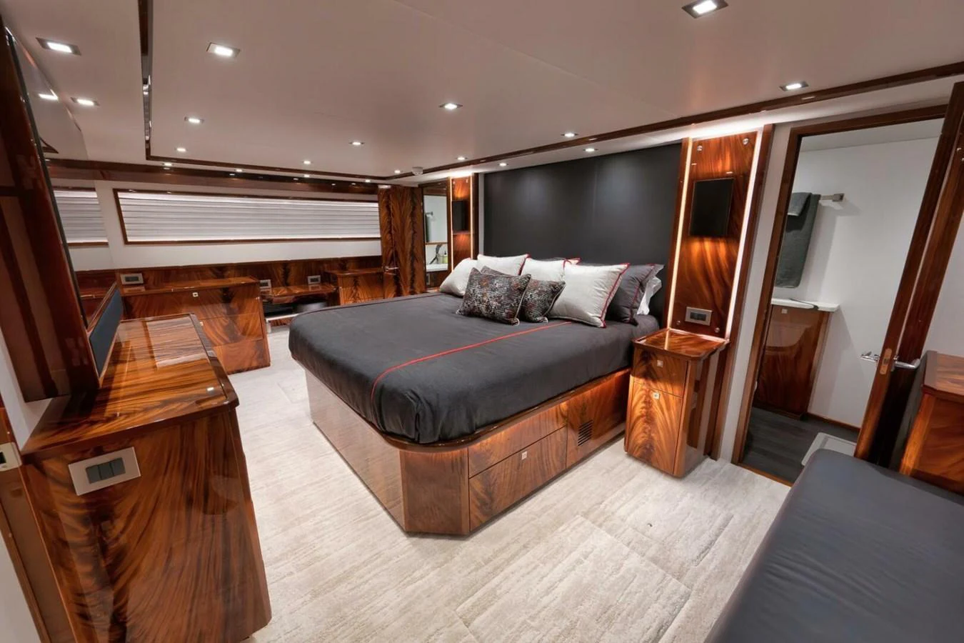 The master stateroom features luxurious wood finishes and a spacious layout with a king-sized bed. aboard NIKKI BELLA Yacht for Sale