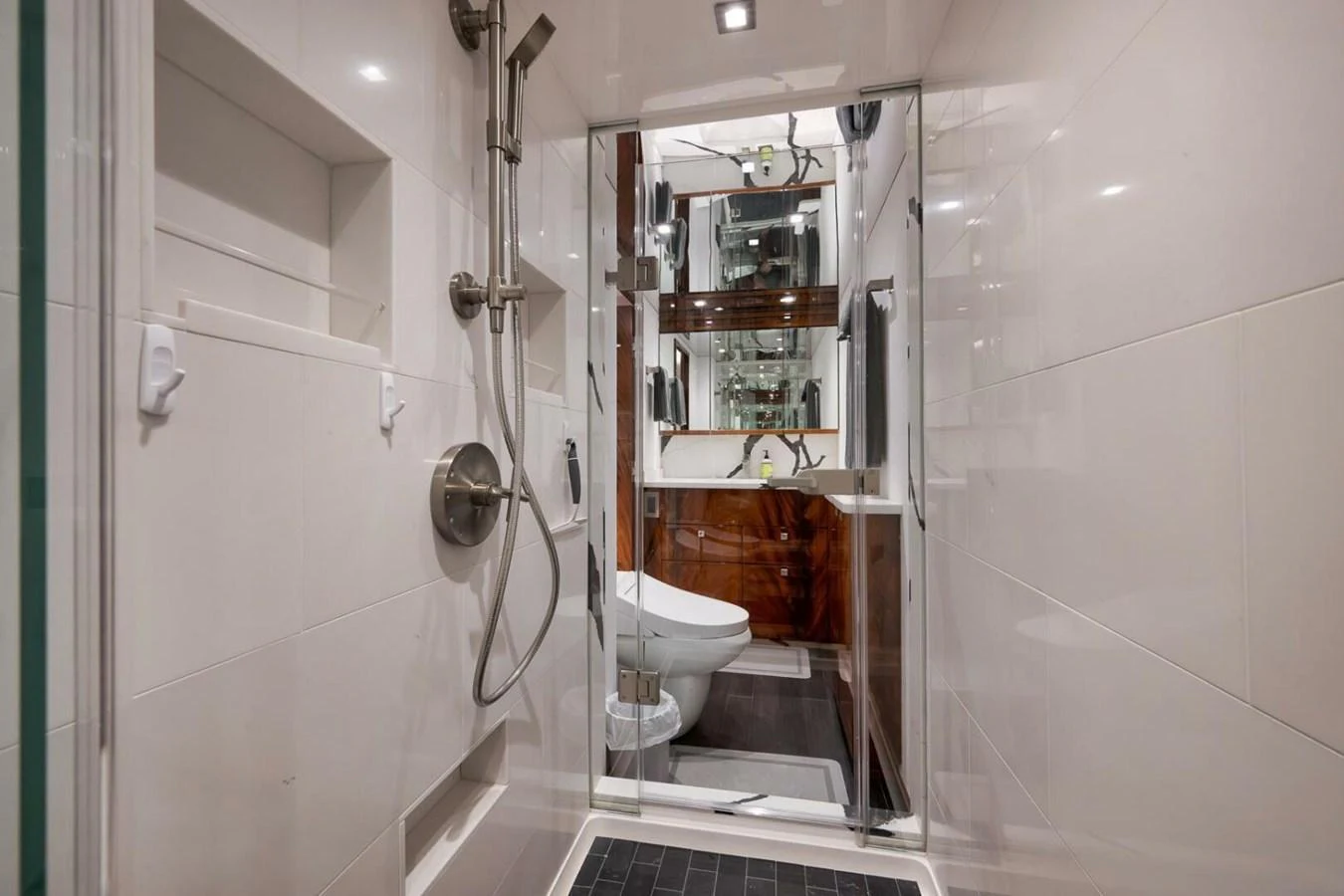 A sleek and modern yacht bathroom featuring a glass-enclosed shower and contemporary fixtures. aboard NIKKI BELLA Yacht for Sale