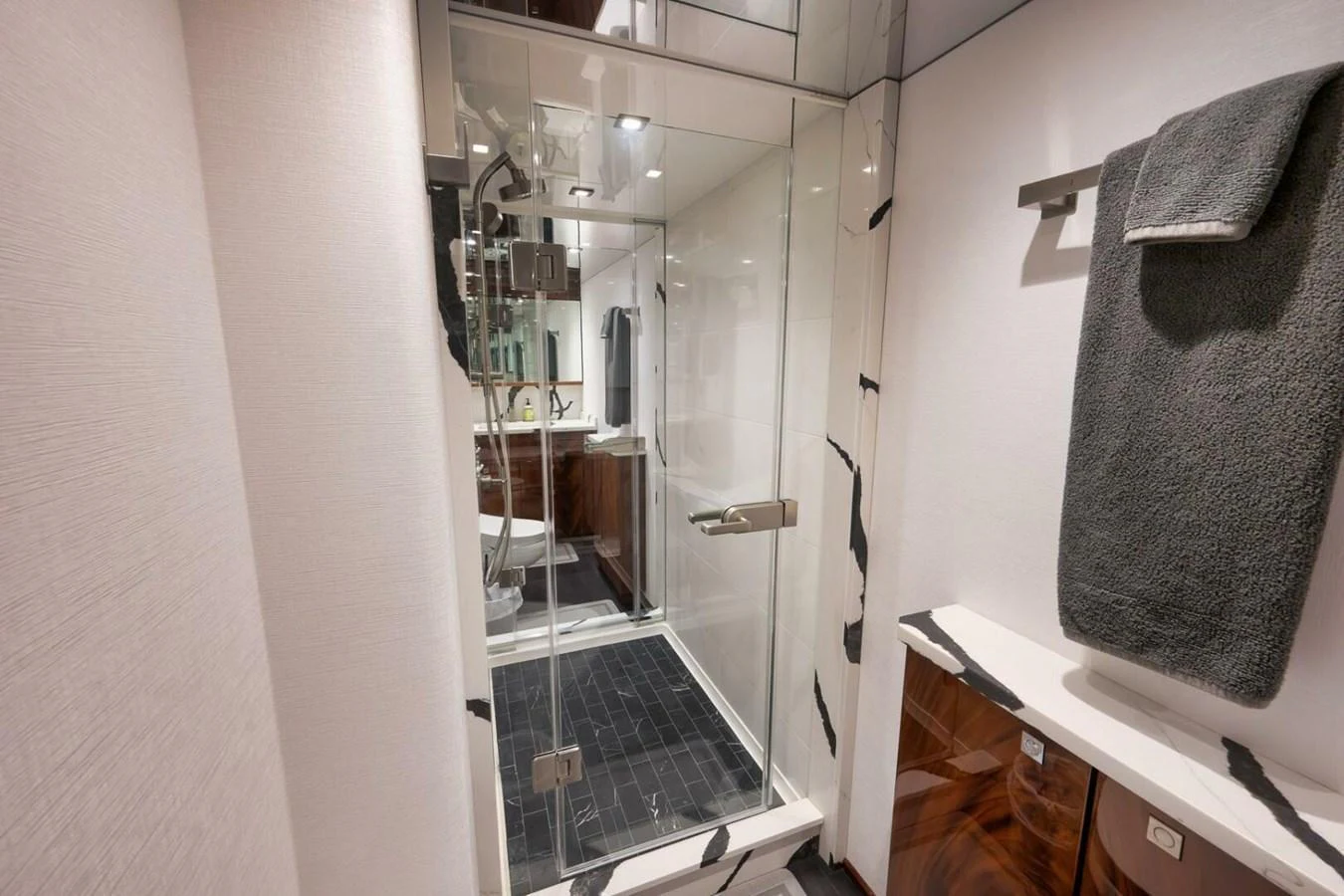 A modern yacht bathroom featuring a glass-enclosed shower and sleek fixtures. aboard NIKKI BELLA Yacht for Sale