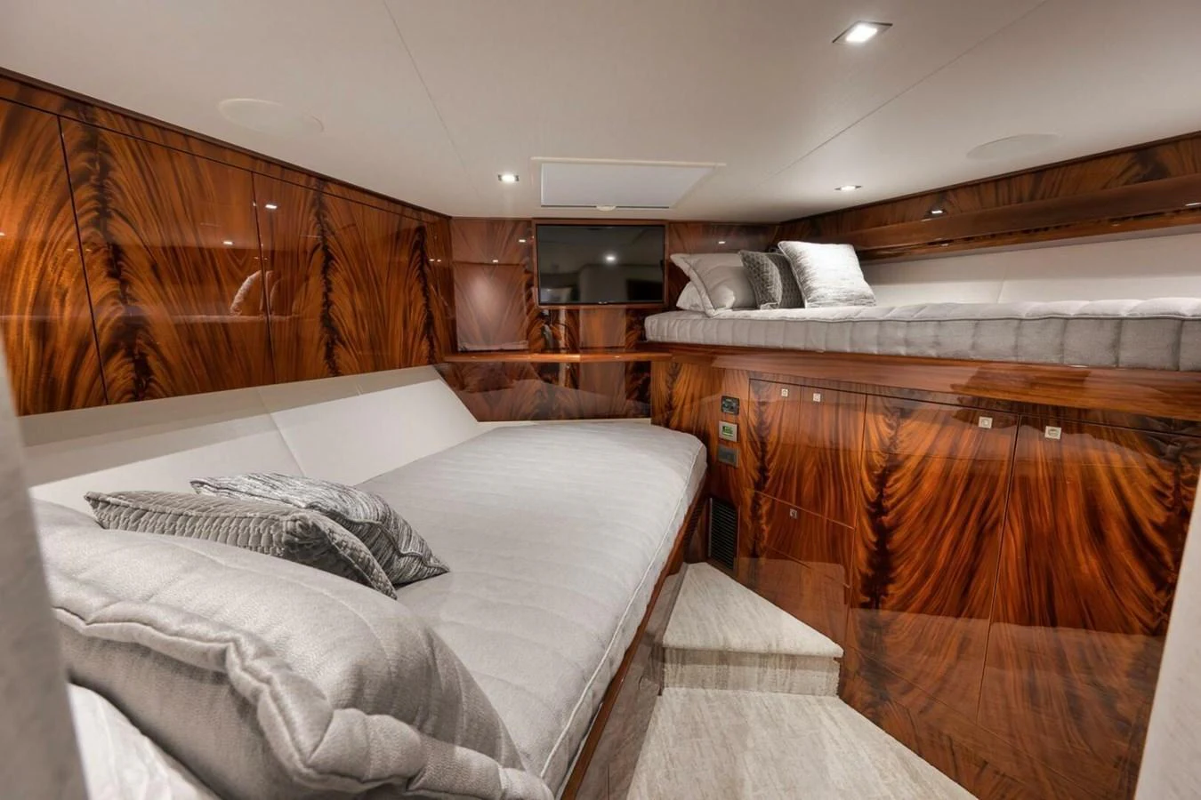 The guest stateroom features luxurious wood paneling and comfortable bedding for a restful stay. aboard NIKKI BELLA Yacht for Sale