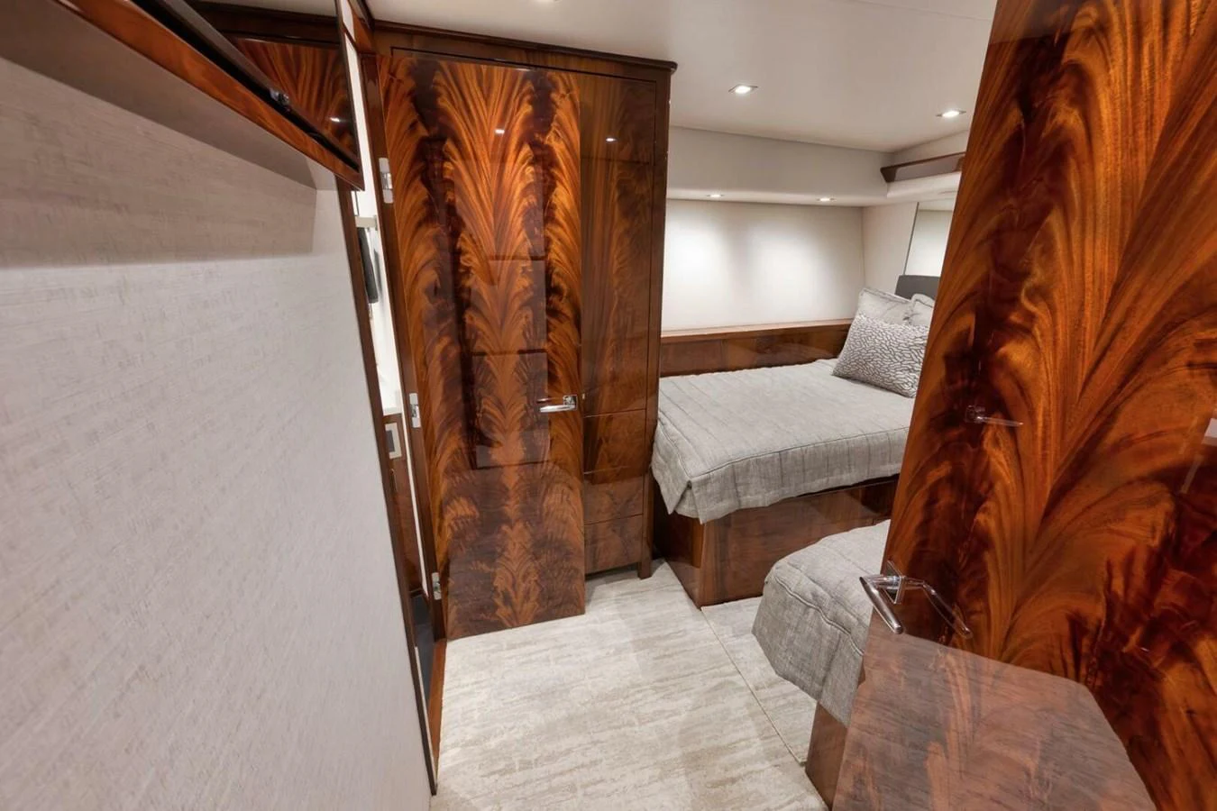 The guest stateroom features elegant wood paneling and a comfortable bed. aboard NIKKI BELLA Yacht for Sale
