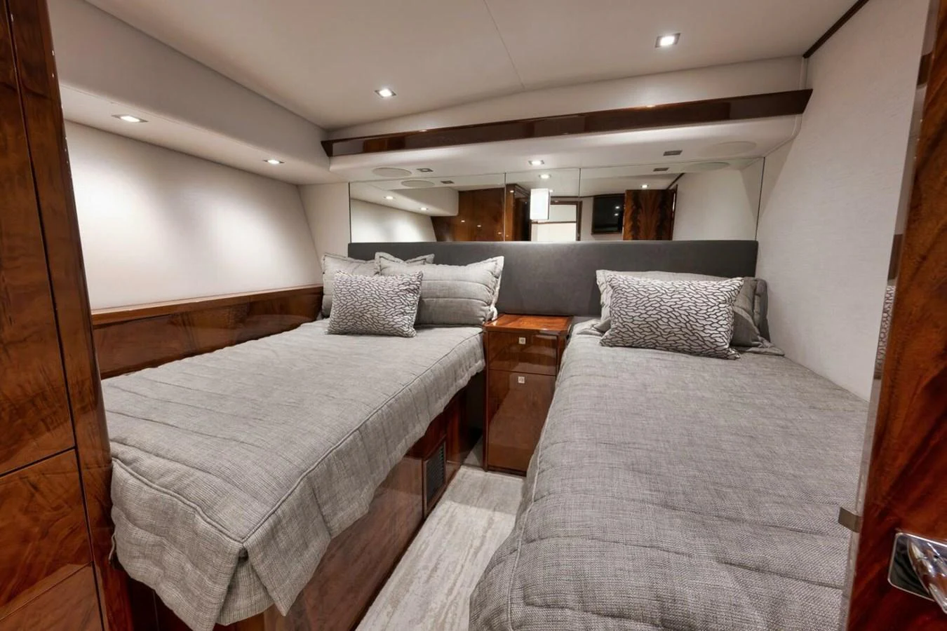 The guest stateroom features twin beds with elegant bedding and warm wood finishes. aboard NIKKI BELLA Yacht for Sale
