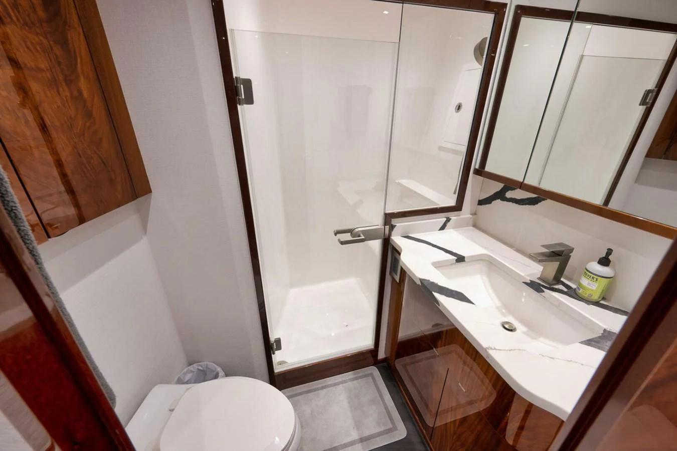 The yacht's bathroom features a sleek design with a glass-enclosed shower and modern fixtures. aboard NIKKI BELLA Yacht for Sale