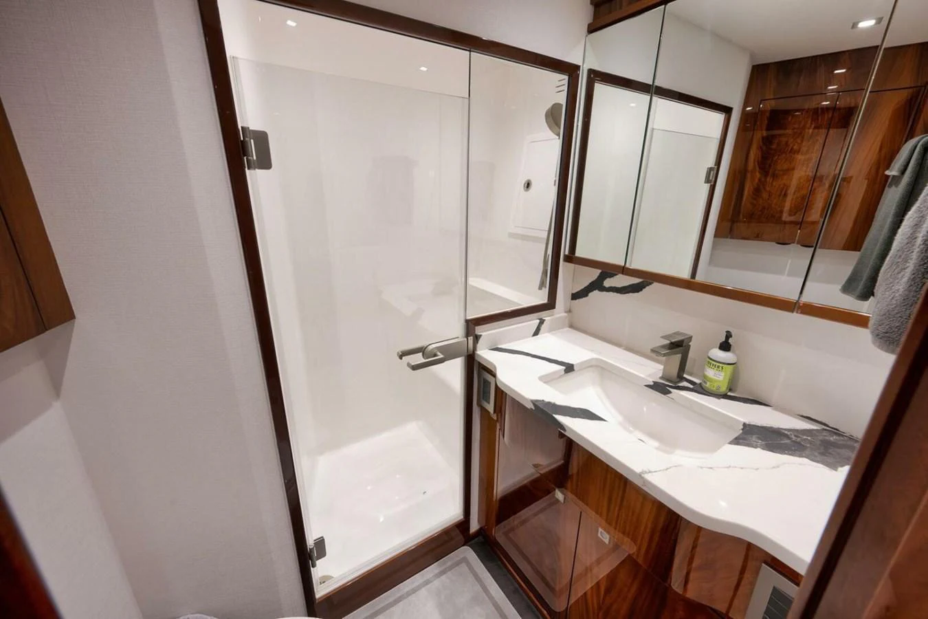 The yacht's bathroom features a sleek design with a glass-enclosed shower and modern fixtures. aboard NIKKI BELLA Yacht for Sale