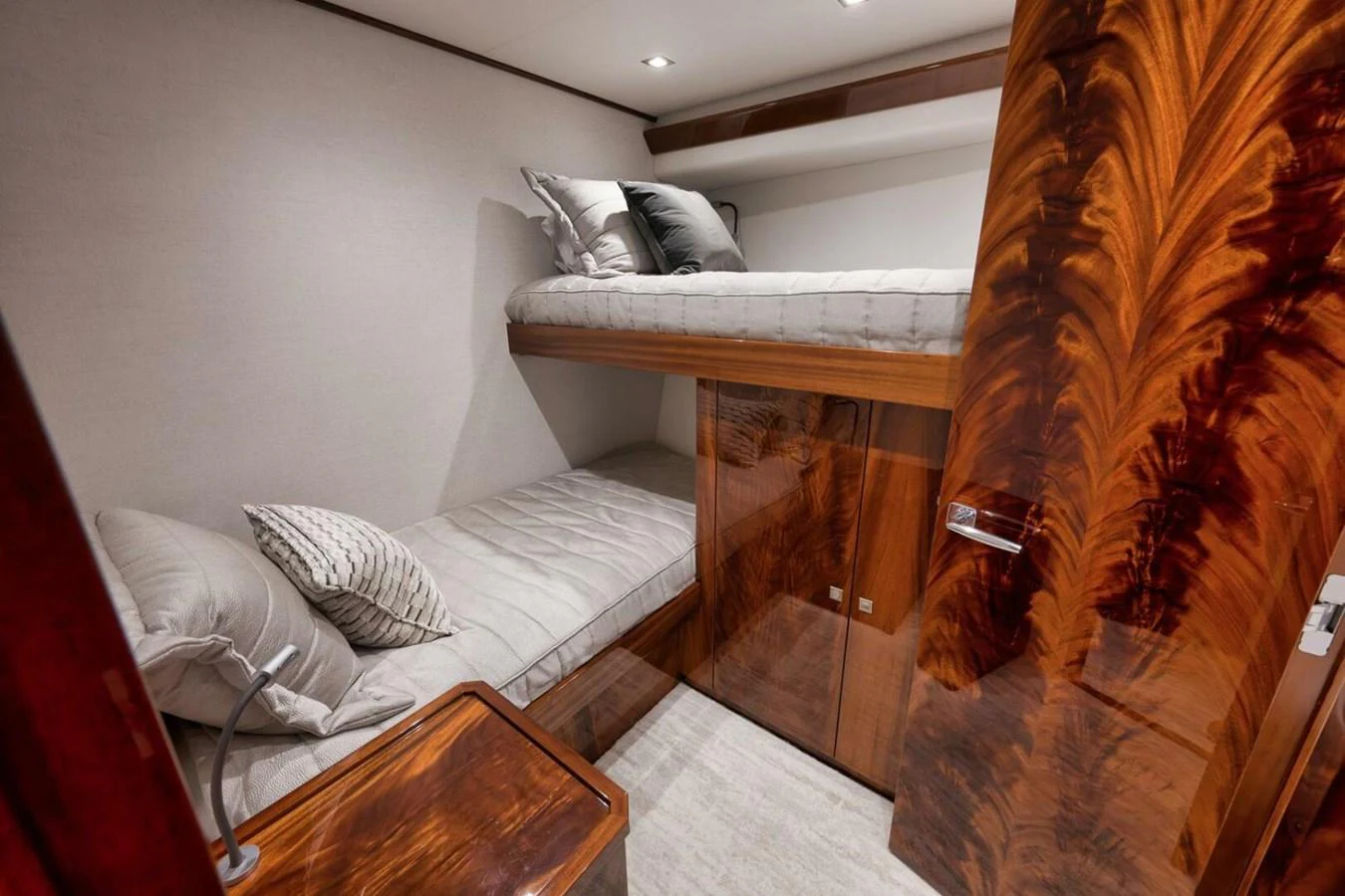 A cozy cabin with bunk beds and luxurious wood finishes. aboard NIKKI BELLA Yacht for Sale