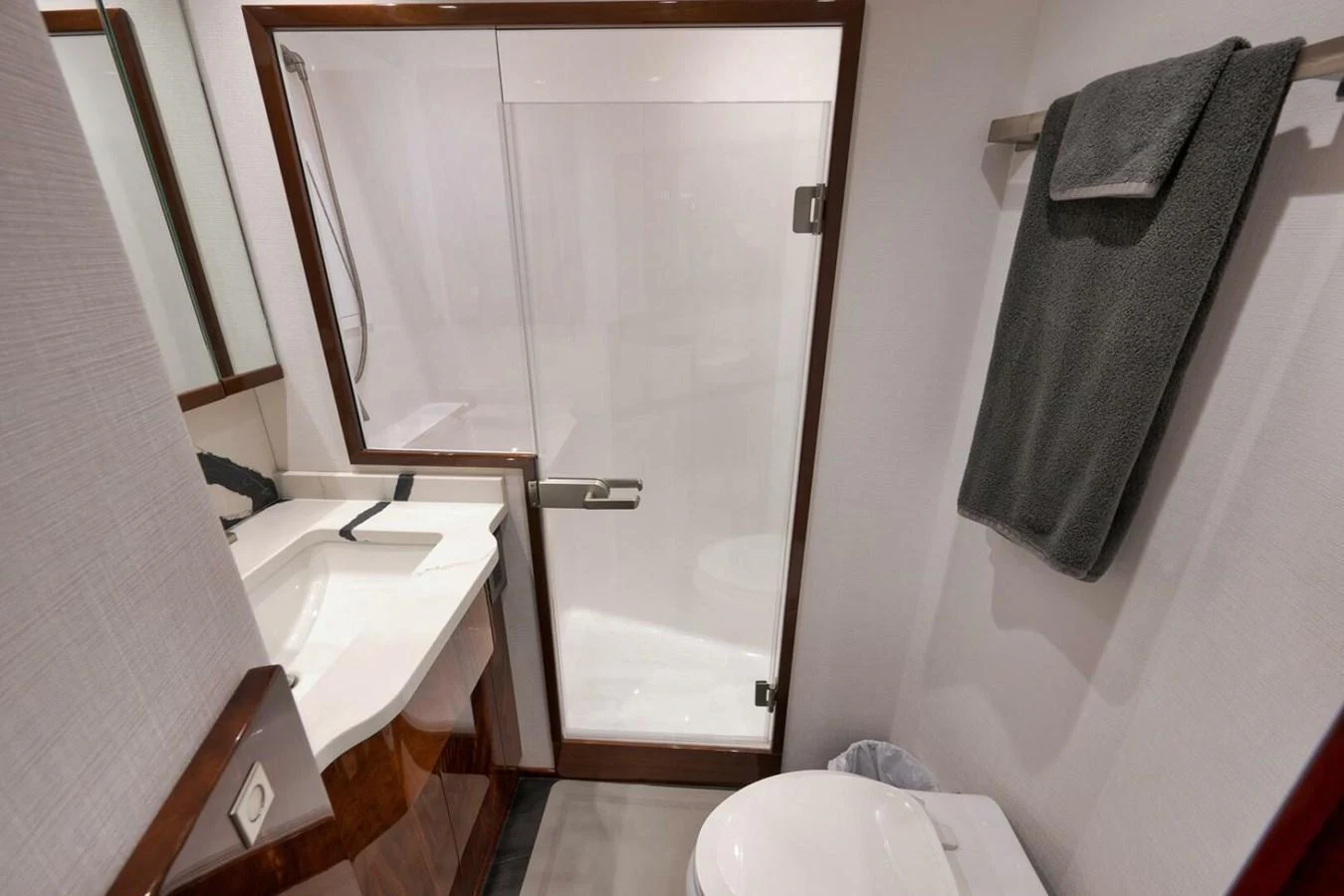 The yacht's bathroom features a sleek design with modern fixtures and a glass-enclosed shower. aboard NIKKI BELLA Yacht for Sale